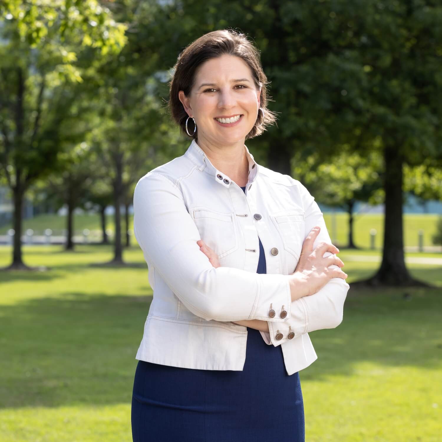 Alison Williams, Coalition Director of Excel by Eight, standing outdoors with a confident and friendly demeanor.