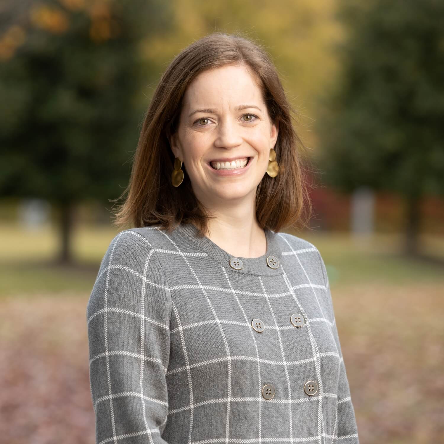 Anna Strong, Executive Director of the Arkansas Chapter of the American Academy of Pediatrics, standing outdoors in professional attire.